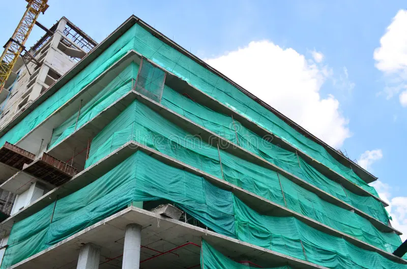 Construction Safety Nets under construction building covered green net safety wrapped debris 74920413 2